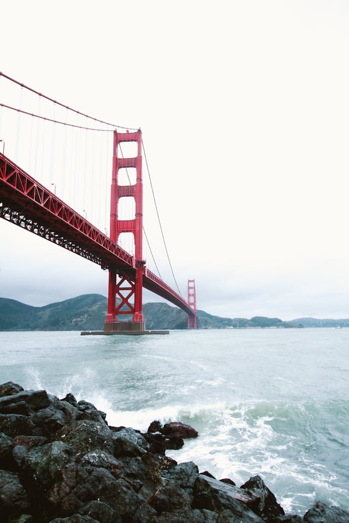 View of the iconic Golden Gate Bridge stretching over the ocean on an overcast day.